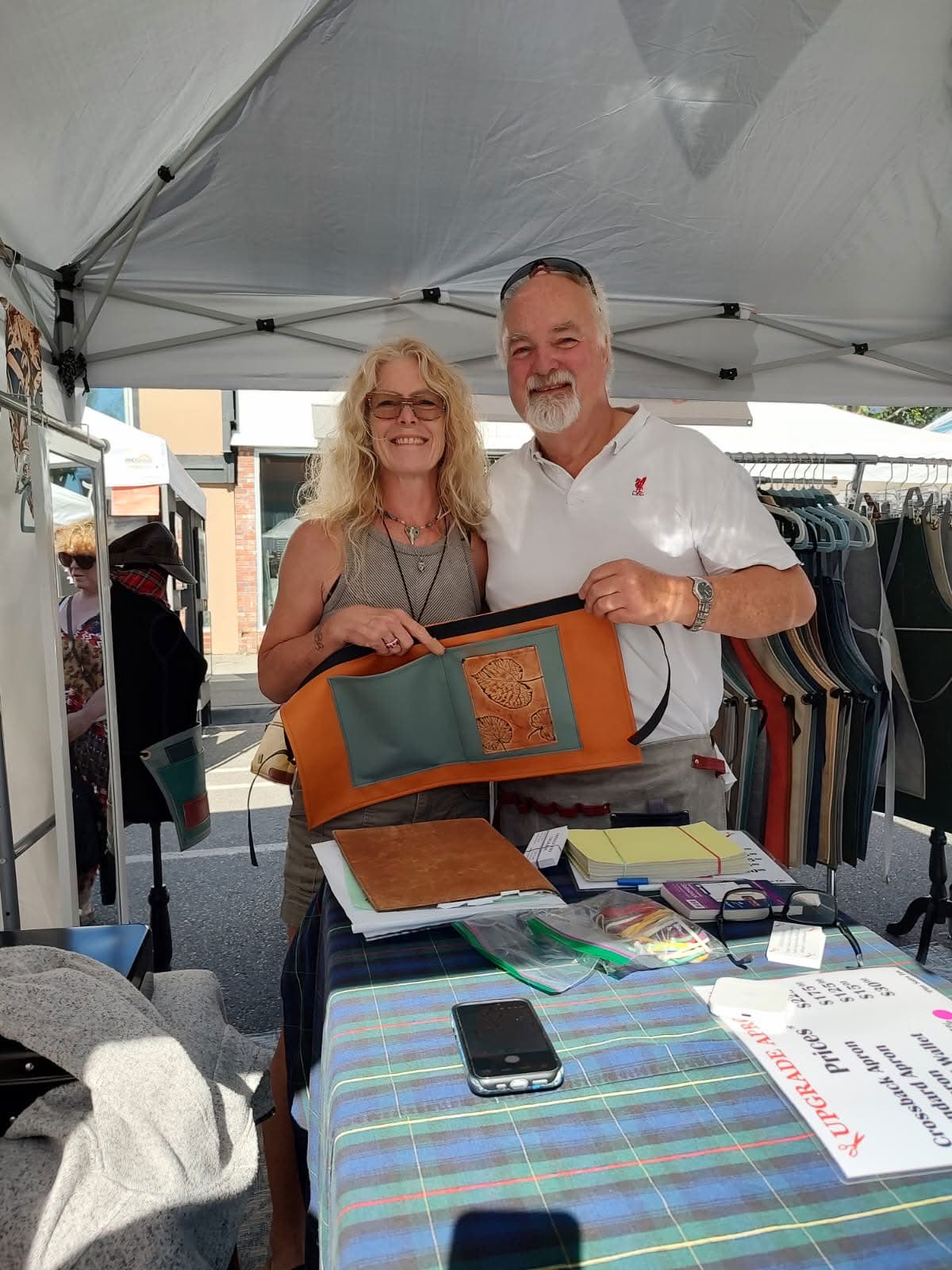 Customer holding a custom Upgrade Apron.